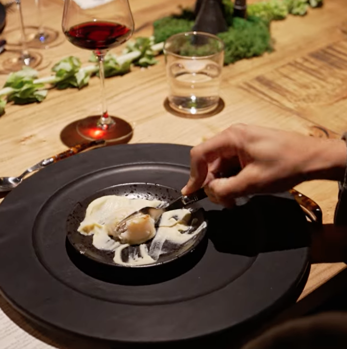 Attendee cutting into a truffle dish.