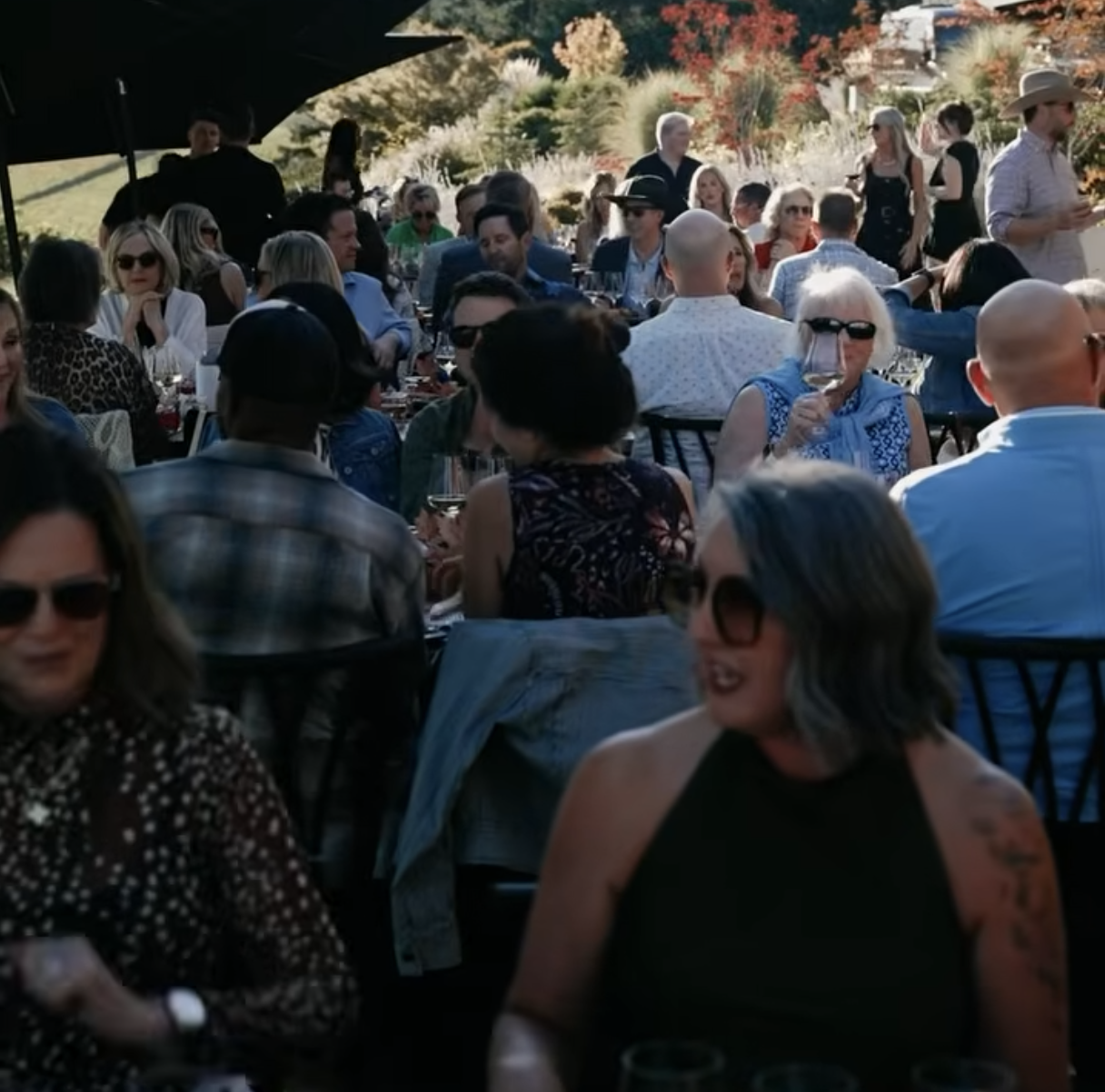 People eating at tables at a harvest party.
